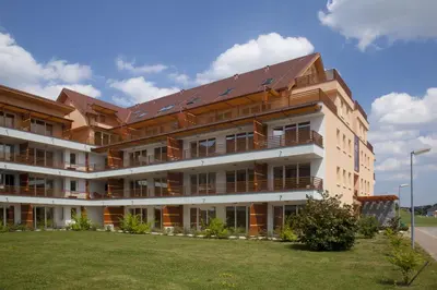 a large white building with a roof on top of it at Apartma Moravske Toplice in Moravske Toplice