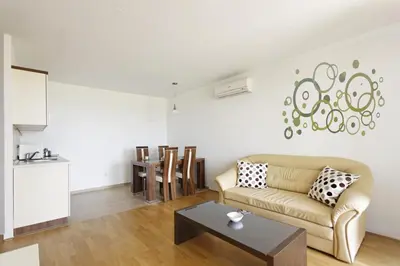 a living room with a couch and a table at Apartma Moravske Toplice in Moravske Toplice