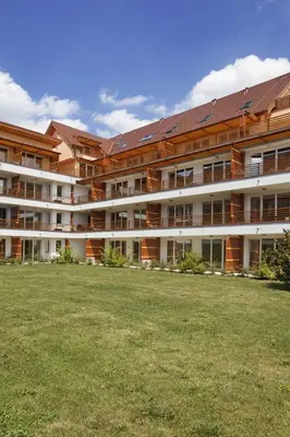 a large building with a grass field in front of it at Apartma Moravske Toplice in Moravske Toplice