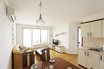 a kitchen and living room with a couch and a table at Apartma Moravske Toplice in Moravske Toplice