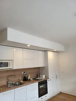 a kitchen with white cabinets and a sink at Sunny AP22 in Bovec