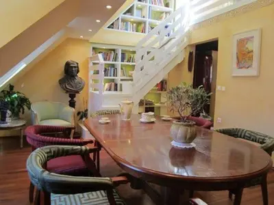 a dining room with a table and chairs and a staircase at A precious apartment in Ljubljana in Ljubljana