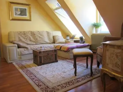 a living room with a couch and a table at A precious apartment in Ljubljana in Ljubljana