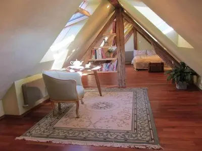 a room with a table and chair in a attic at A precious apartment in Ljubljana in Ljubljana