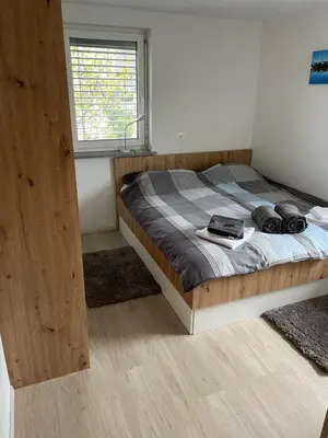 a bedroom with a bed in a room with a window at Ten villages in Žirovnica