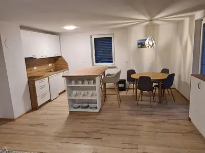 a kitchen and dining room with a table and chairs at Ten villages in Žirovnica