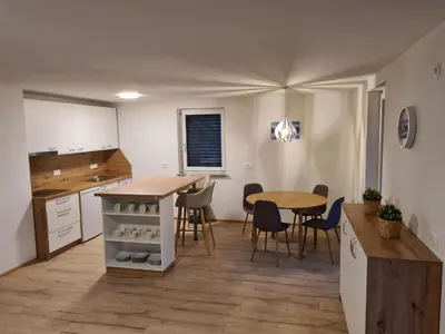 a kitchen and dining room with a table and chairs at Ten villages in Žirovnica