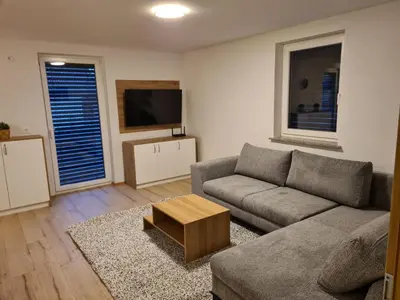 a living room with a couch and a coffee table at Ten villages in Žirovnica