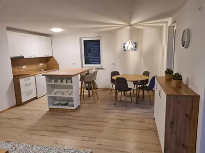 a kitchen and dining room with a table and chairs at Ten villages in Žirovnica