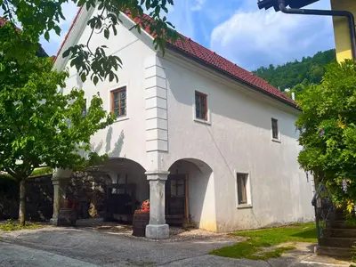 a white building with an archway in front of it at Holiday home in Semic - Kranjska (Krain) 51757 in Semič