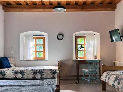a bedroom with two beds and a desk and two windows at Holiday home in Semic - Kranjska (Krain) 51757 in Semič
