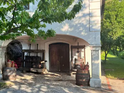 a building with a door with barrels in front of it at Holiday home in Semic - Kranjska (Krain) 51757 in Semič