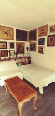 a bedroom with two beds and a coffee table at Dom AteLJe in Ljubljana