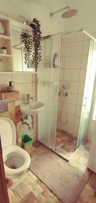 a bathroom with a toilet and a sink at Dom AteLJe in Ljubljana