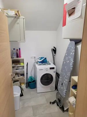a kitchen with a washing machine in a room at Kranj Leisure Apartment in Kranj