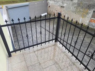 an iron fence with spikes on a balcony at Kranj Leisure Apartment in Kranj