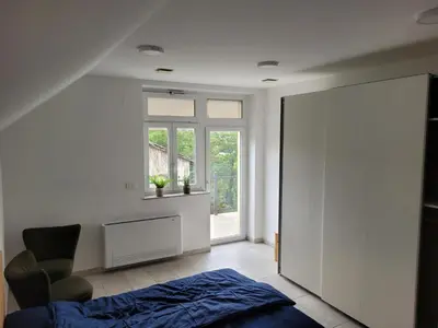 a bedroom with a bed and a window at Kranj Leisure Apartment in Kranj