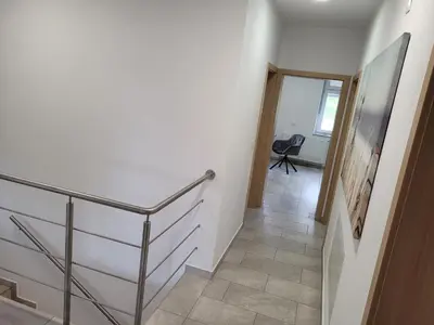 a hallway with a staircase and a stair case at Kranj Leisure Apartment in Kranj