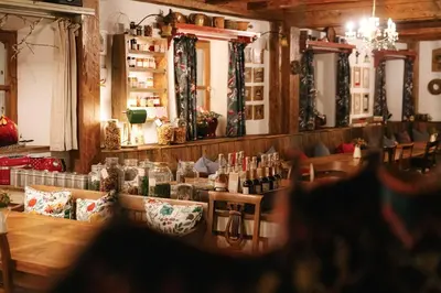 a restaurant with a table with bottles of wine at Guesthouse Novak -Modern Barn Loft in Dvor