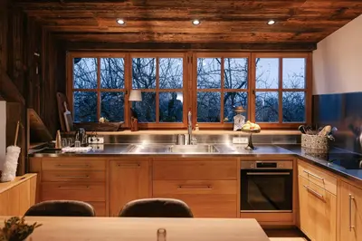 a kitchen with a sink and some windows at Guesthouse Novak -Modern Barn Loft in Dvor