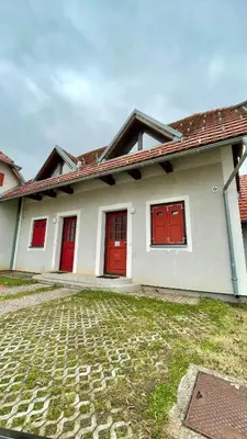 a house with red doors and a brick driveway at Terme Čatež apartma Maestro in Čatež ob Savi