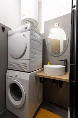 a bathroom with a washing machine and a sink at Celje City Stay in Celje