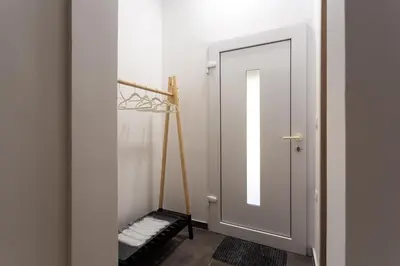 a bathroom with a mirror and a door with towels at Celje City Stay in Celje