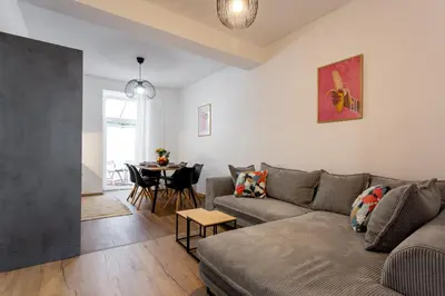 a living room with a couch and a table at Celje City Stay in Celje