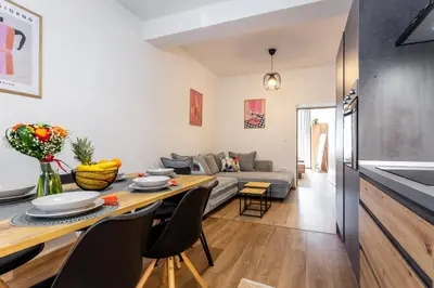 a living room with a table and a couch at Celje City Stay in Celje