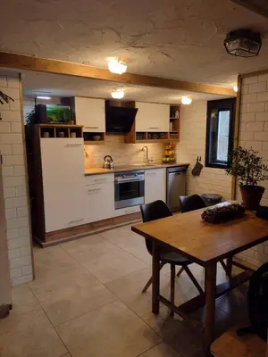 a kitchen with a wooden table and a dining room at Holiday apartement Sentjur in Šentjur