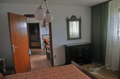 a living room with a fireplace and a mirror at Apartments MM in Muta