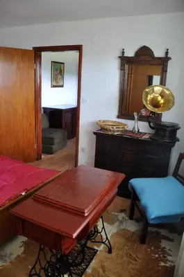 a room with a bed and a table and a mirror at Apartments MM in Muta