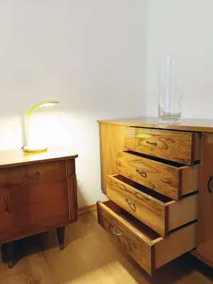 a dresser with a lamp on top of it next to a drawer at Apartma Vodrice in Slappe dʼIdria