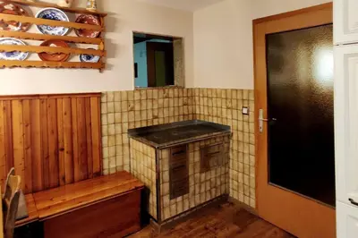 a kitchen with a tiled wall with a counter top at Cozy 3BR Alpine House in Gozd Martuljek