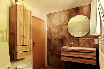 a bathroom with a sink and a mirror at Cozy 3BR Alpine House in Gozd Martuljek