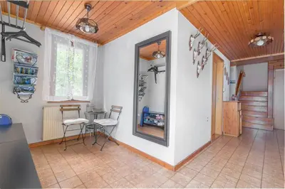 a room with a mirror and a table and chairs at Cozy 3BR Alpine House in Gozd Martuljek