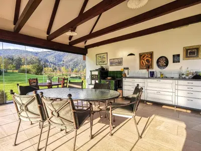 a kitchen and dining room with a table and chairs at Geratičevo in Lovrenc na Pohorju