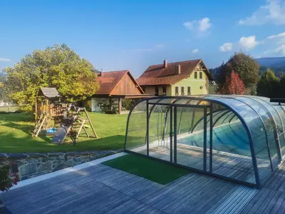 a pool house with a glass enclosure on a deck at Geratičevo in Lovrenc na Pohorju