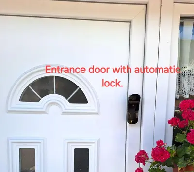 an entrance door with an automatic look sign on it at Apartma Studio Bogi in Kranjska Gora