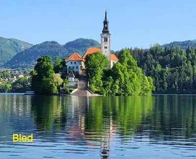 a church on an island in the middle of a lake at Apartma Studio Bogi in Kranjska Gora