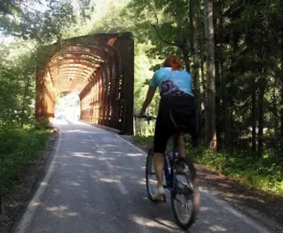 a person riding a bike down a road at Apartma Studio Bogi in Kranjska Gora