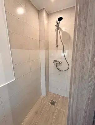 a bathroom with a shower with a shower head at Apartment Bon Voyage II in Maribor