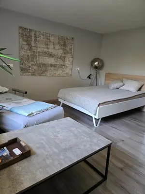 a room with two beds and a coffee table at Apartma dolgi most in Ljubljana