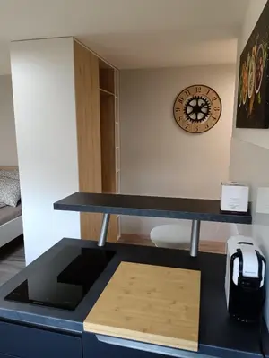 a desk in a room with a clock on the wall at Apartma dolgi most in Ljubljana