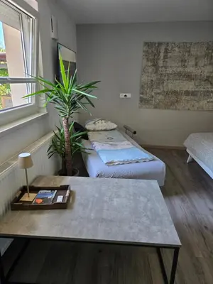 a small room with two beds and a table at Apartma dolgi most in Ljubljana