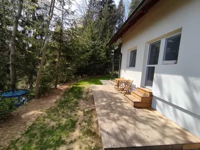 a porch of a house with a wooden deck at apartma Pohorc - Praprot in Pohorje