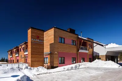 a building with snow in front of it at Hotel Natura in Zreče