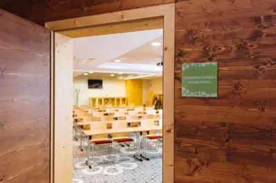 a conference room with tables and chairs in the background at Hotel Natura in Zreče