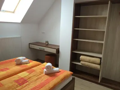 a bedroom with a bed and a book shelf at Apartmaji Kranjska Gora in Kranjska Gora