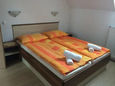 a bedroom with a bed with two pillows on it at Apartmaji Kranjska Gora in Kranjska Gora